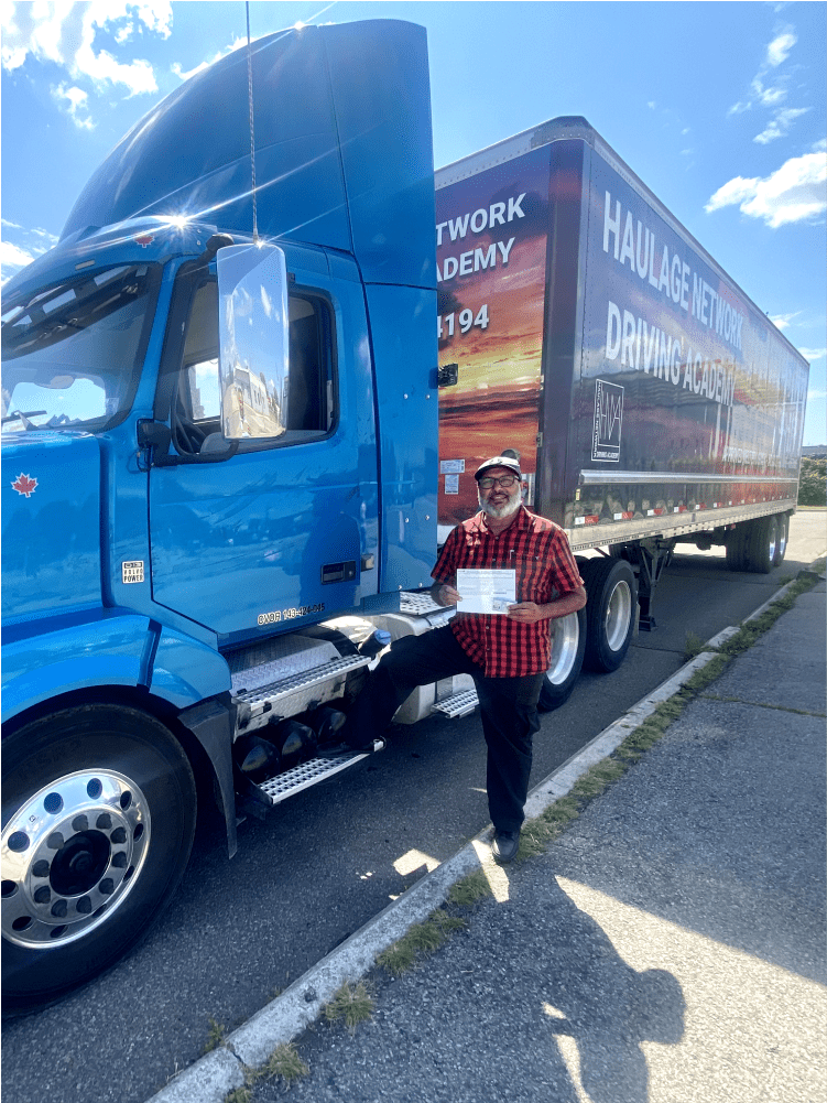 student holding their new cdl license