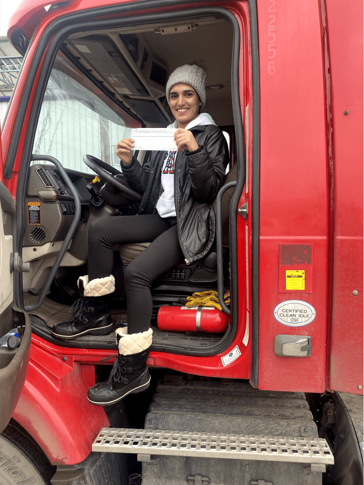 student holding their new cdl license